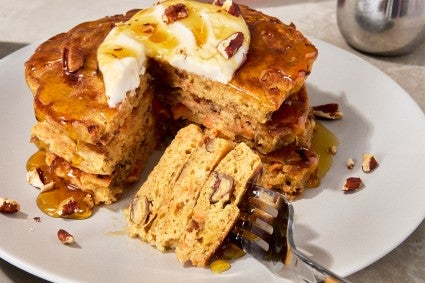 Carrot Cake Pancakes on a plate with a slice taken out