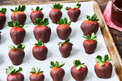 chocolate dipped strawberries on a sheet pan