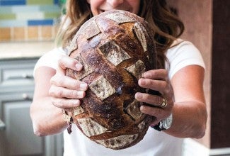 Maura Brickman holding a loaf of her bread